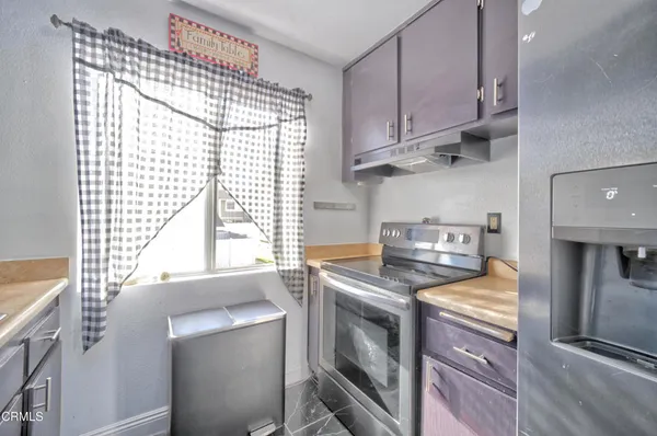 a kitchen with a stove and a white refrigerator