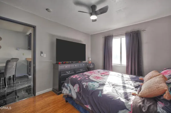 a bedroom with a bed and a flat screen tv