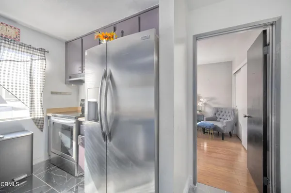 a en suite bathroom with a granite countertop sink and a mirror
