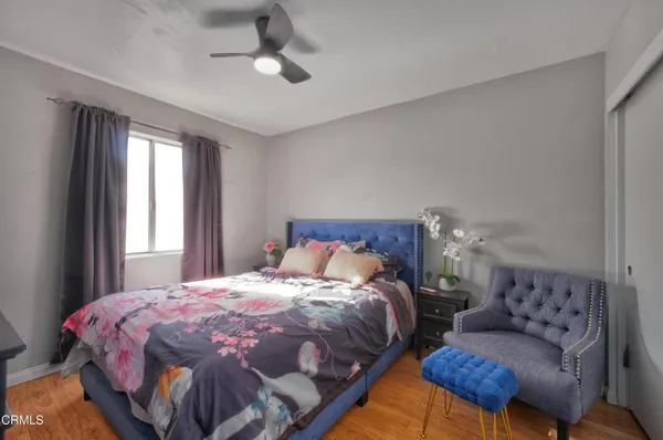 a bedroom with a bed and ceiling fan