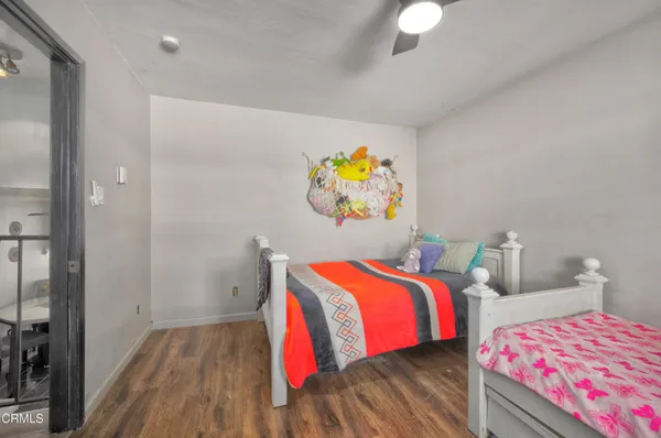 a bedroom with two beds and a chandelier