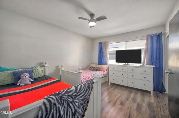 a bedroom with furniture and a flat screen tv