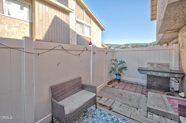 a backyard of a house with outdoor seating