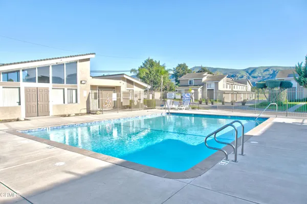 a view of a swimming pool with a lounge chairs