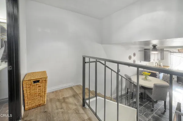 a view of staircase with railing and white walls