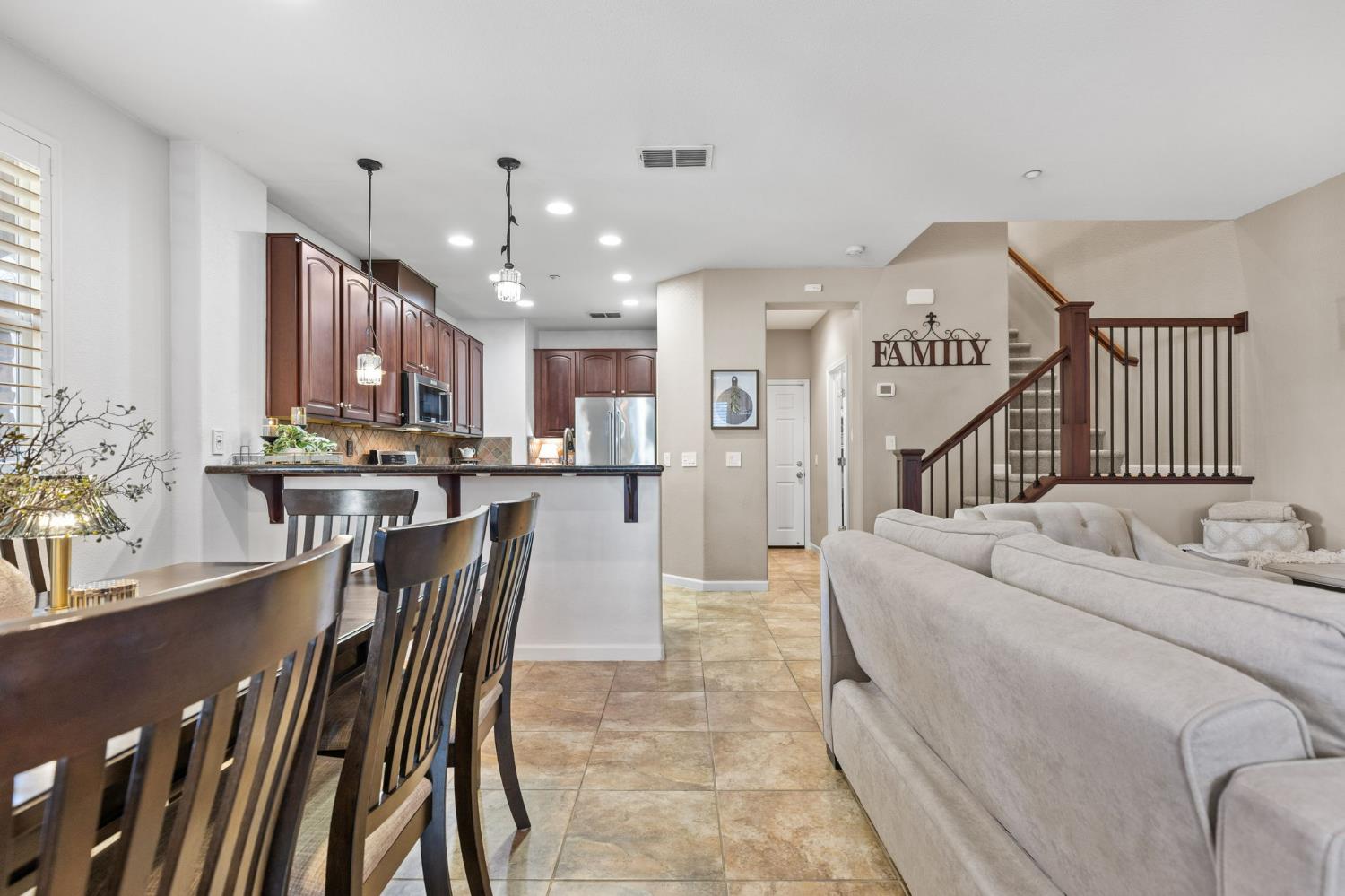 1107 Hudson Circle Lincoln, CA 95648 - Photo 12 of 51 The spacious downstairs includes high ceilings, recessed lighting, a ceiling fan, spacious dining area, updated kitchen, custom built stair railing to match the kitchen, half bathroom, storage closet, and direct access to the garage