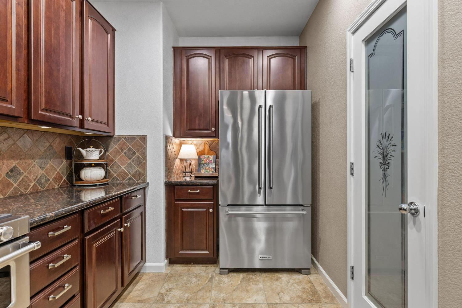 1107 Hudson Circle Lincoln, CA 95648 - Photo 18 of 51 a kitchen with a refrigerator stove and cabinets