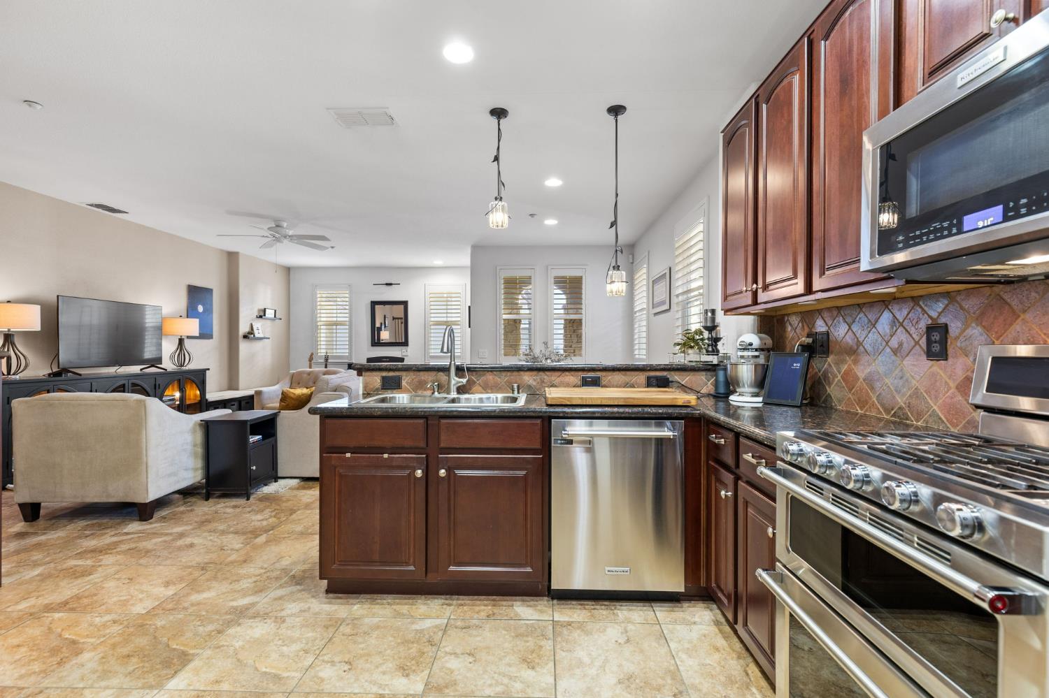 1107 Hudson Circle Lincoln, CA 95648 - Photo 20 of 51 a kitchen with stainless steel appliances granite countertop a stove top oven a sink dishwasher and cabinets