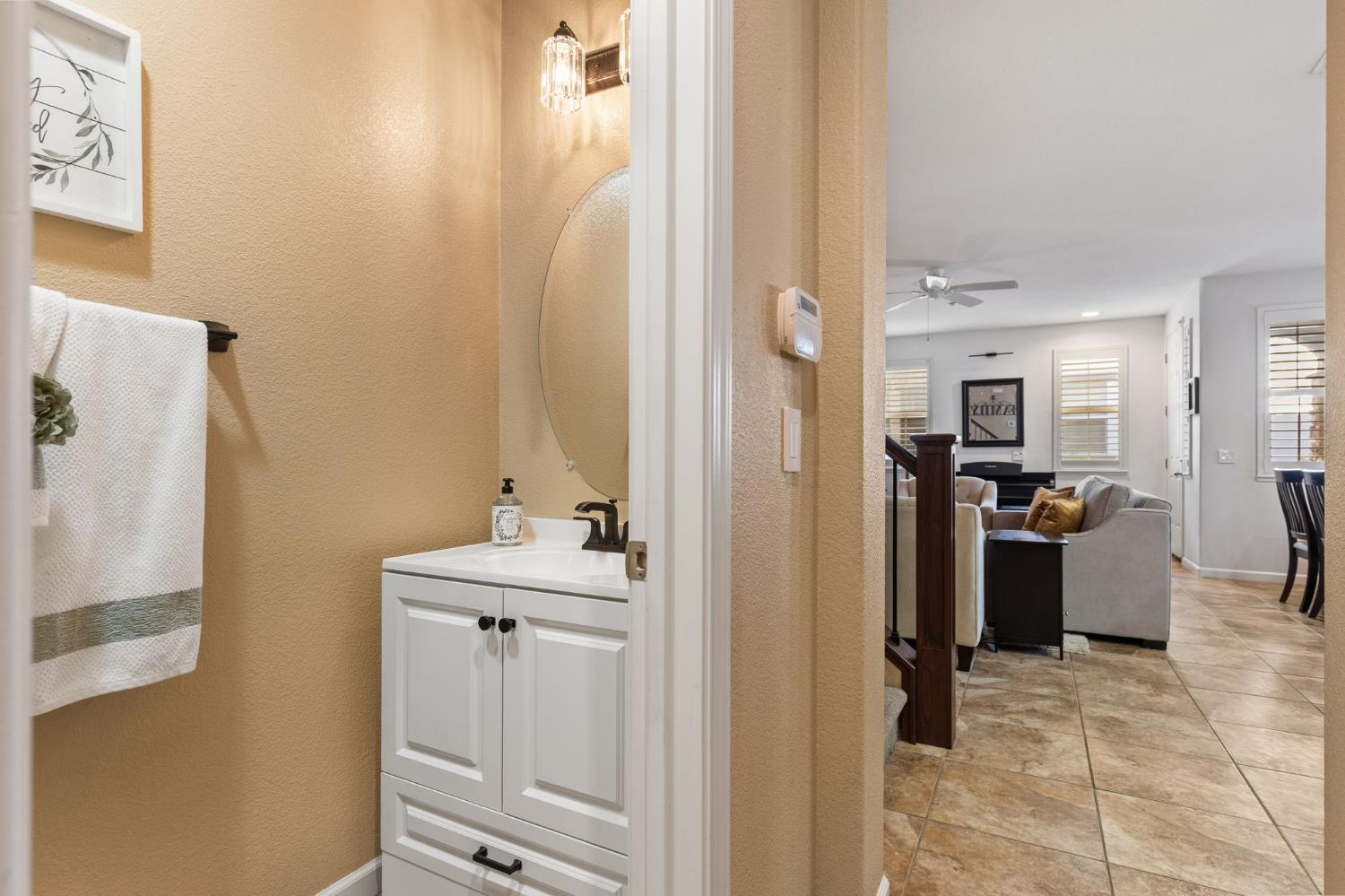 1107 Hudson Circle Lincoln, CA 95648 - Photo 24 of 51 Updated half-bathroom downstairs with updated lighting that coordinates with dining bar pendants and decorative accent shelves