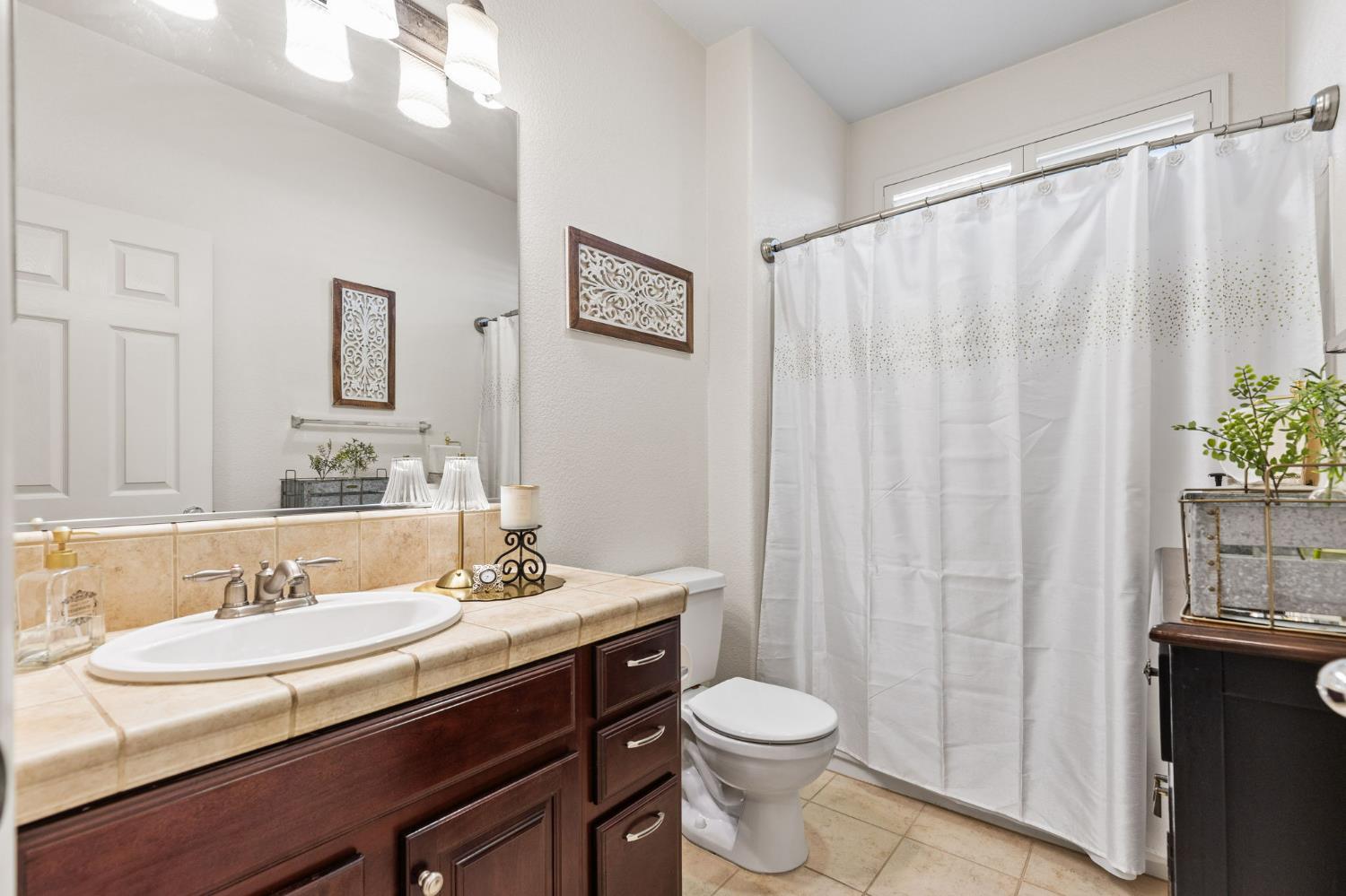 1107 Hudson Circle Lincoln, CA 95648 - Photo 30 of 51 a bathroom with a granite countertop sink and a mirror