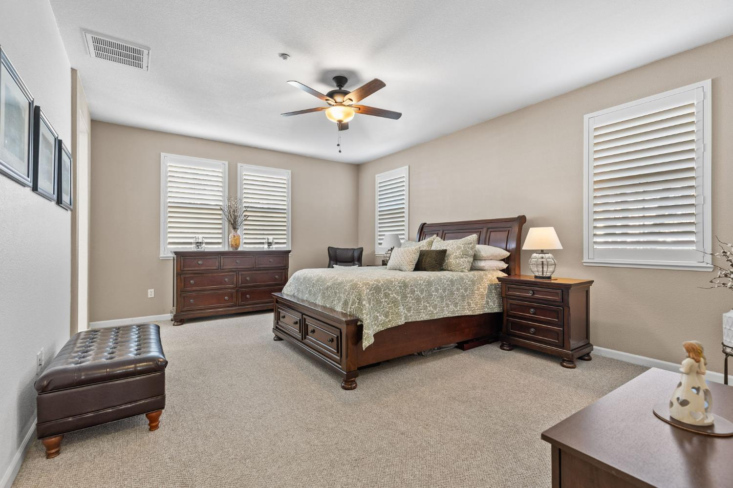 1107 Hudson Circle Lincoln, CA 95648 - Photo 35 of 51 a bedroom with a bed and a chandelier