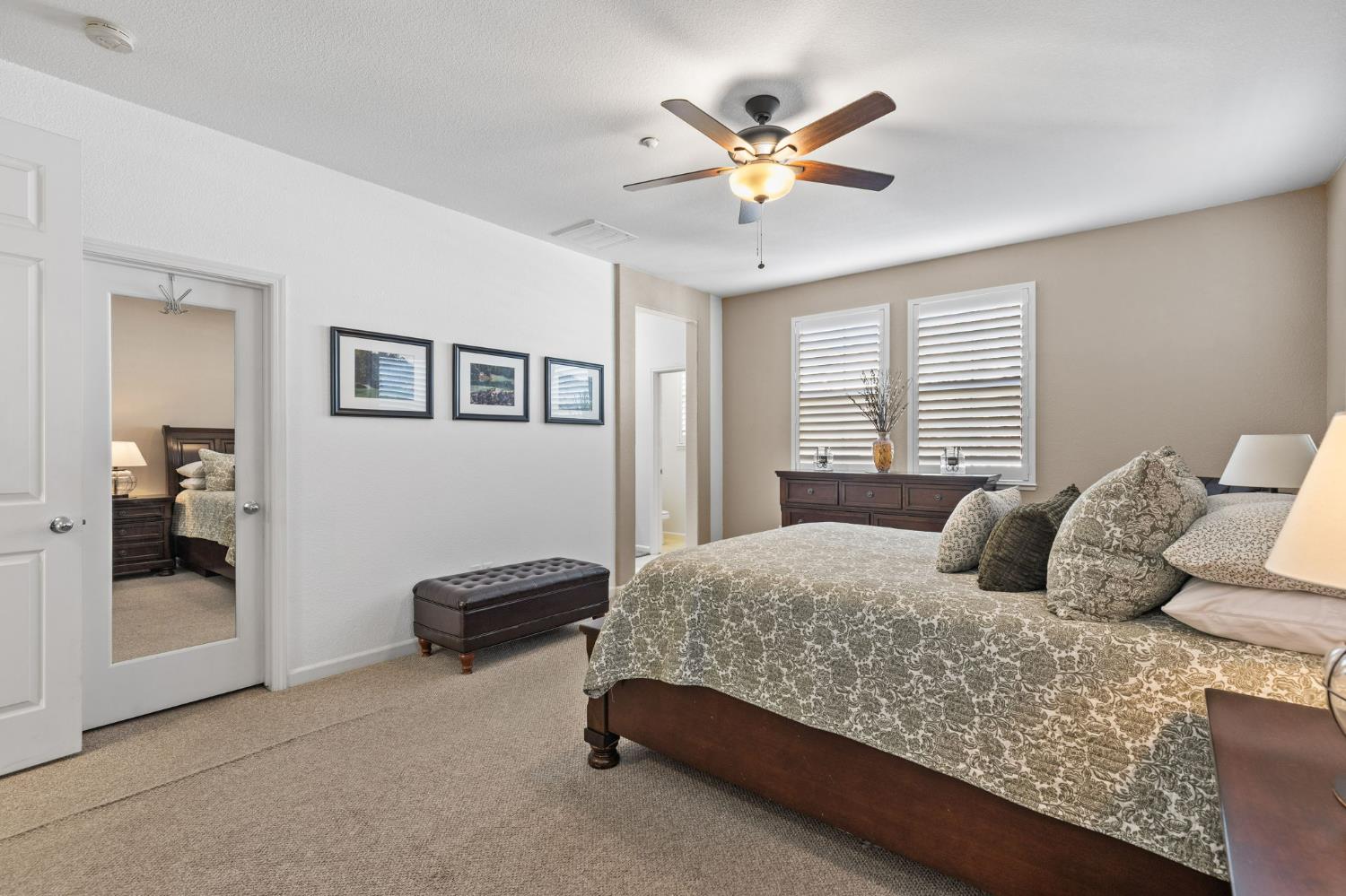 1107 Hudson Circle Lincoln, CA 95648 - Photo 36 of 51 a bedroom with a large bed and a chandelier