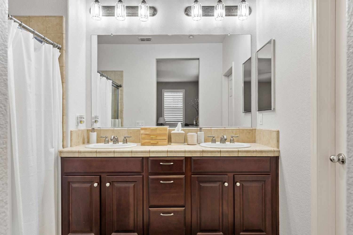1107 Hudson Circle Lincoln, CA 95648 - Photo 39 of 51 a bathroom with a double vanity sink and a mirror