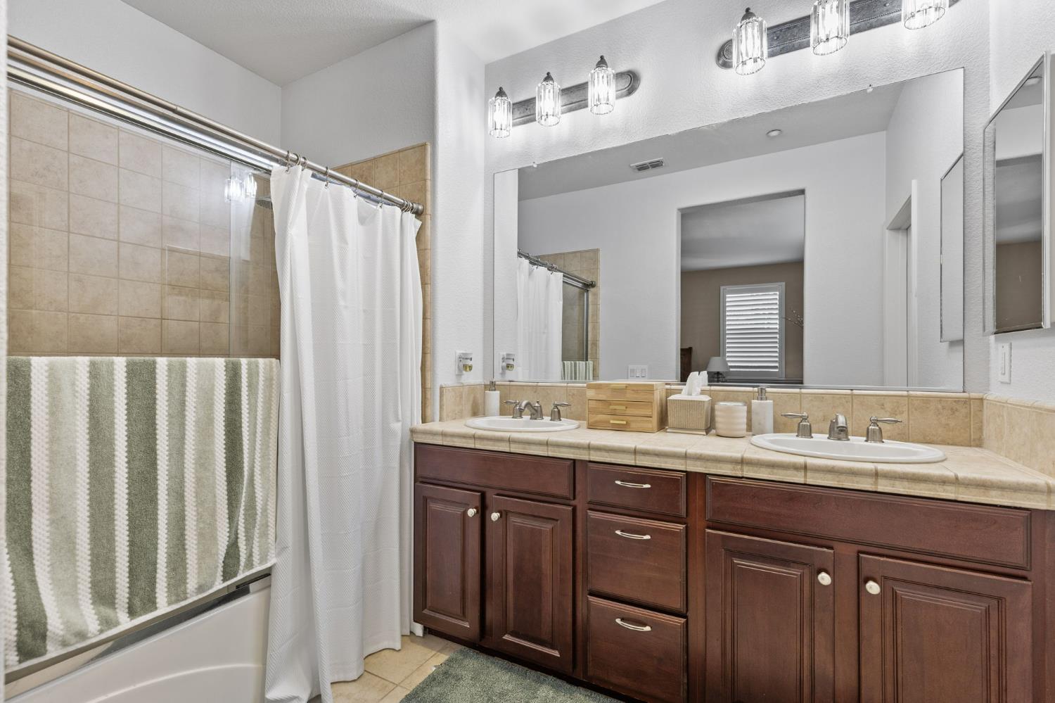 1107 Hudson Circle Lincoln, CA 95648 - Photo 40 of 51 a bathroom with a double vanity sink and a mirror