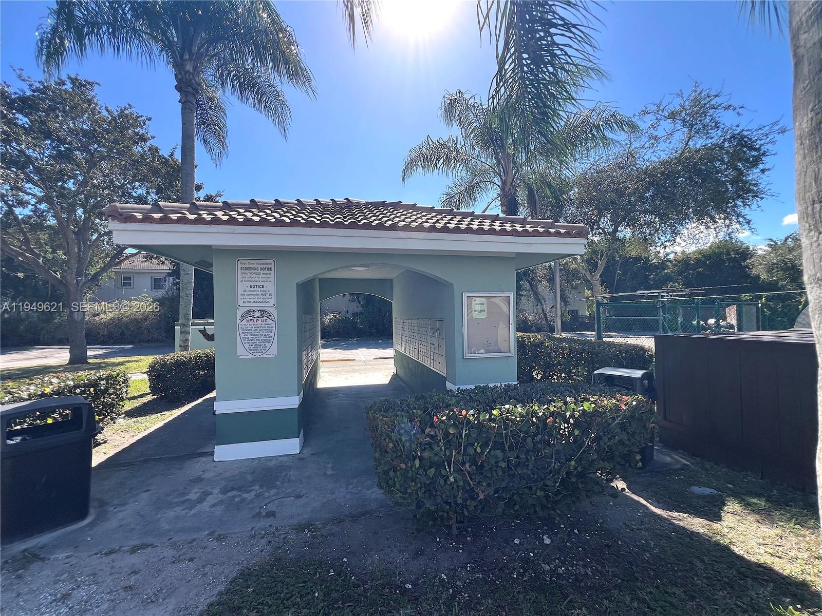 1660 Southeast 29th Street, Unit 101 Homestead, FL 33035 - Photo 16 of 18 a front view of a house with a yard