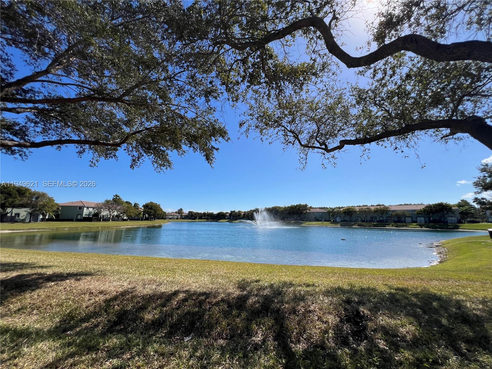 1660 Southeast 29th Street, Unit 101 Homestead, FL 33035 - Photo 17 of 18 a view of a lake with houses in the back