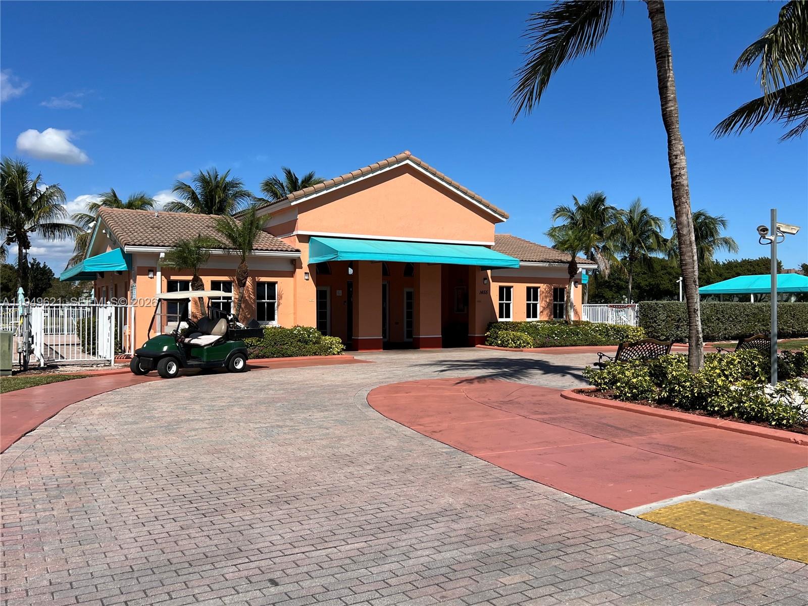 1660 Southeast 29th Street, Unit 101 Homestead, FL 33035 - Photo 18 of 18 a front view of a house with yard and parking