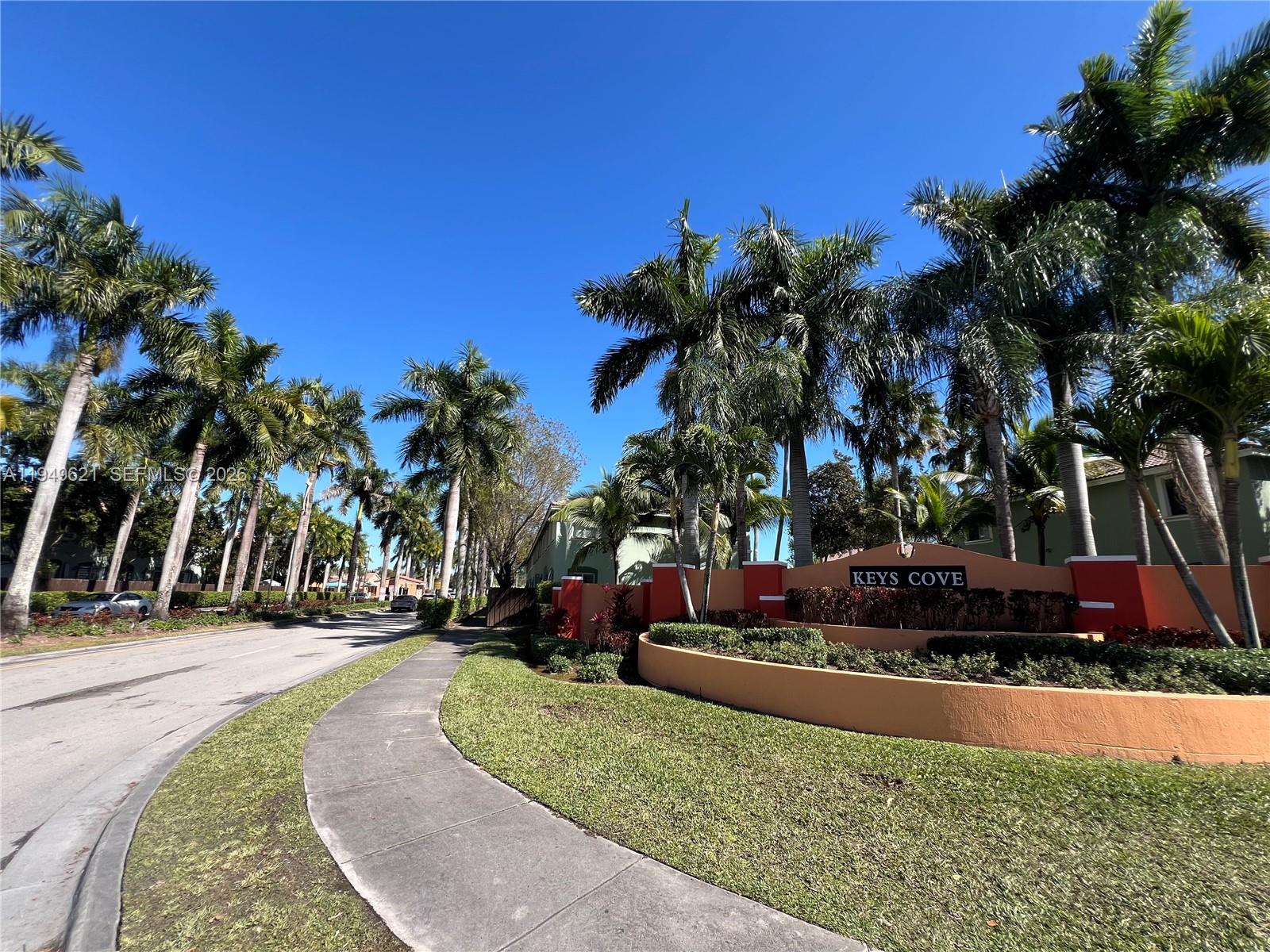 1660 Southeast 29th Street, Unit 101 Homestead, FL 33035 - Photo 2 of 18 a view of a yard with palm trees