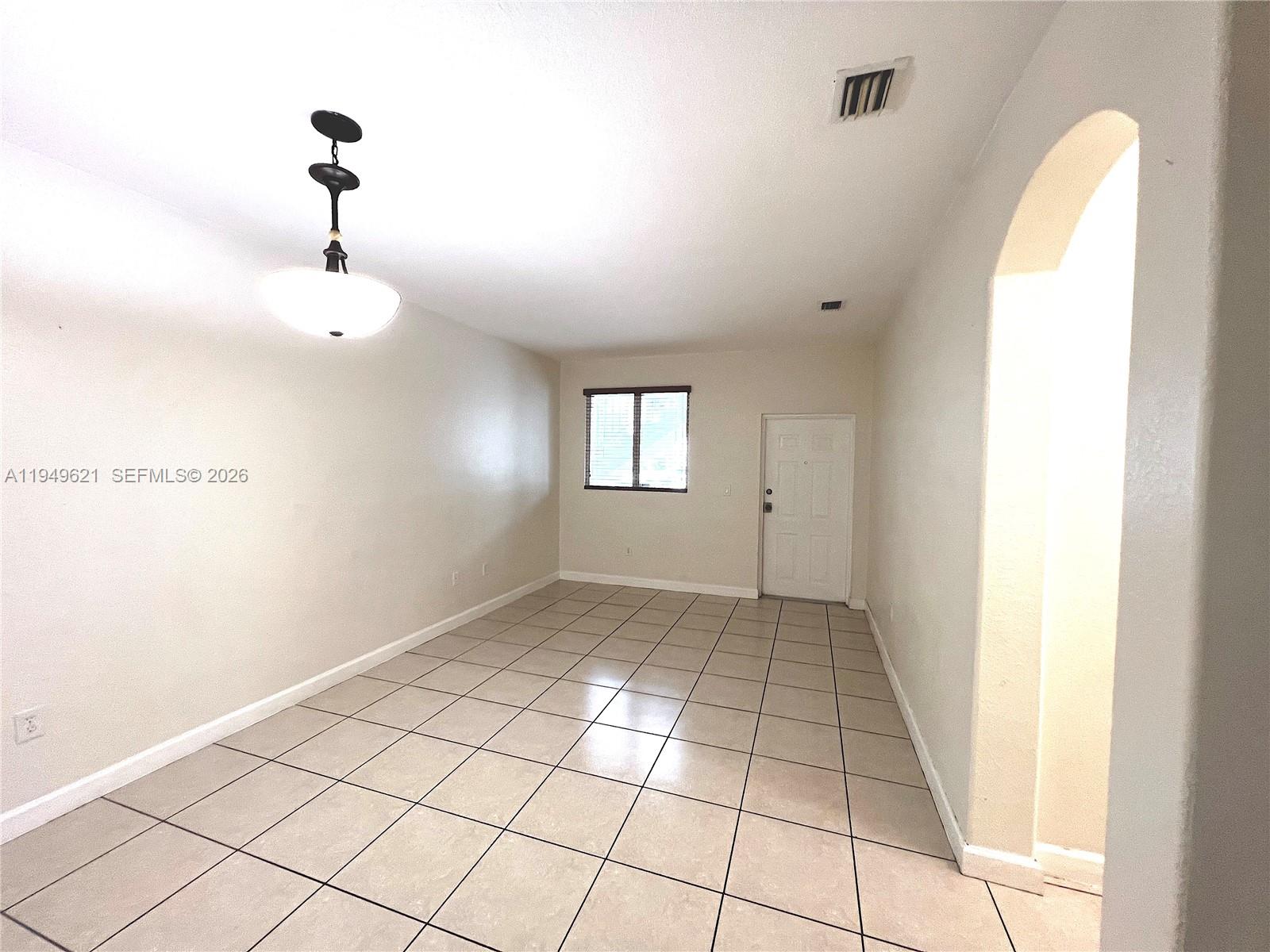 1660 Southeast 29th Street, Unit 101 Homestead, FL 33035 - Photo 6 of 18 a view of an empty room and window