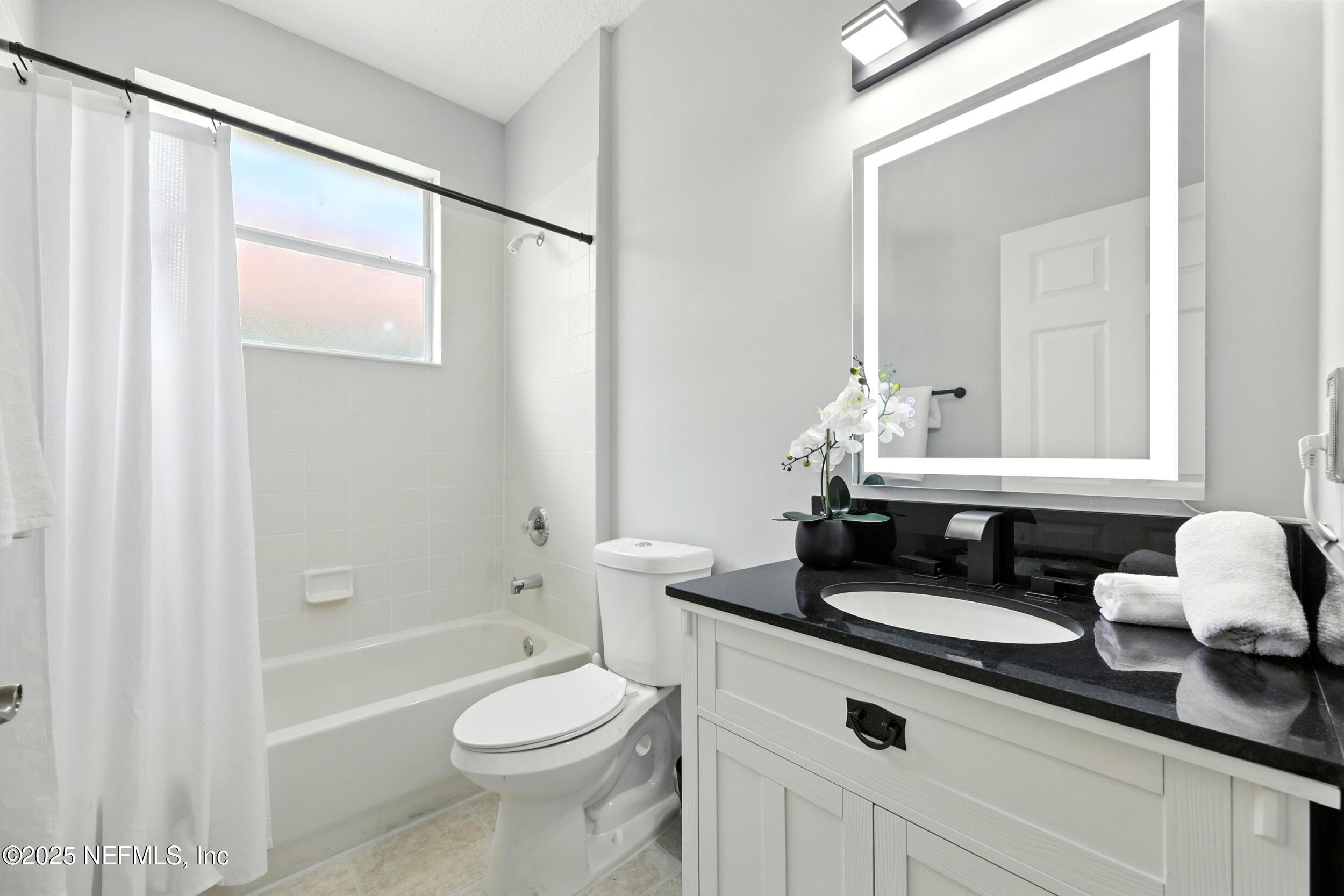 778 Copperhead Circle St. Augustine, FL 32092 - Photo 18 of 43 a bathroom with a granite countertop sink a toilet a mirror and shower