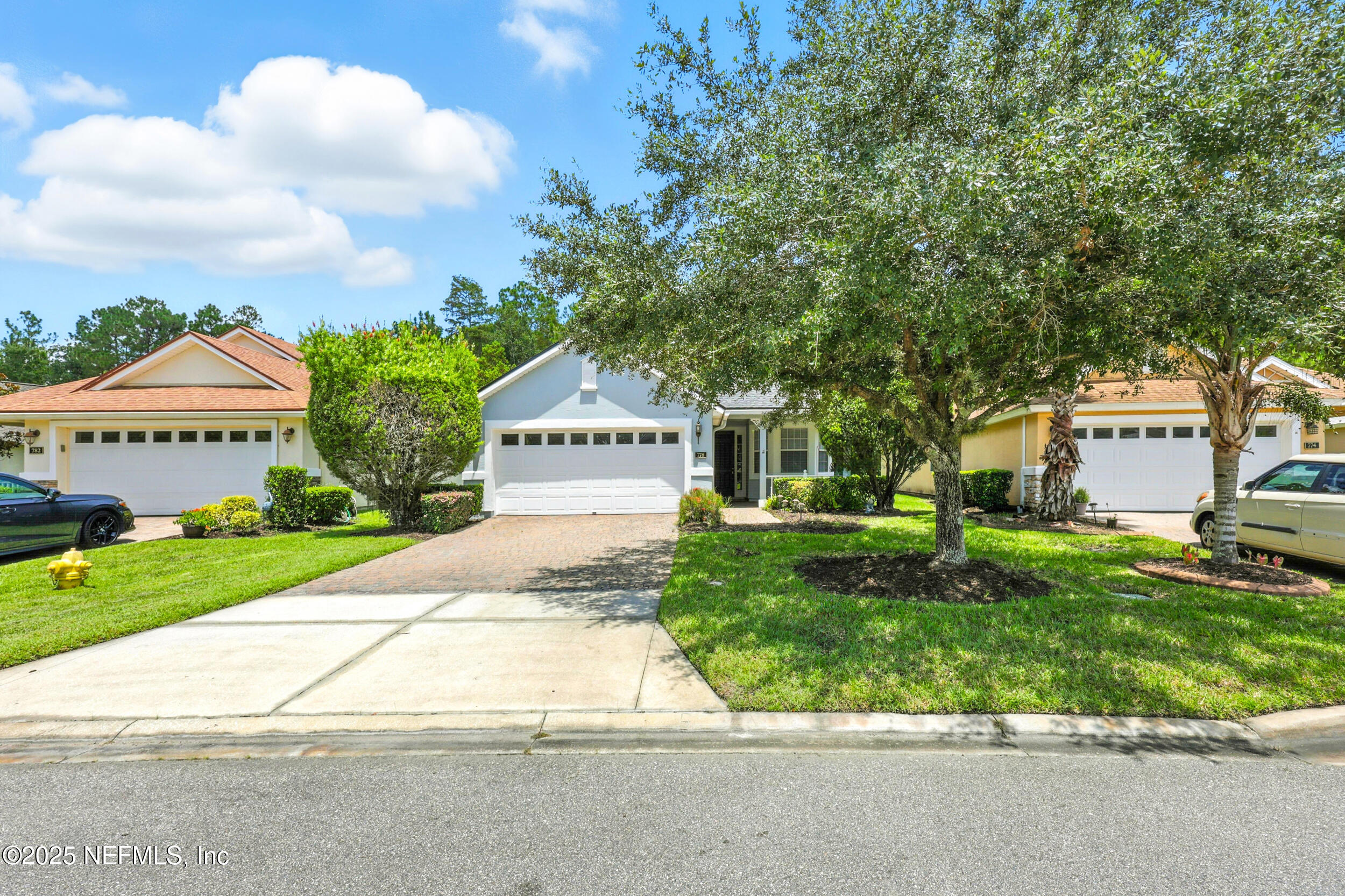 778 Copperhead Circle St. Augustine, FL 32092 - Photo 26 of 43 a front view of a house with a yard and a garage