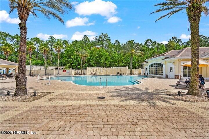 778 Copperhead Circle St. Augustine, FL 32092 - Photo 37 of 43 a backyard of a house with table and chairs plants