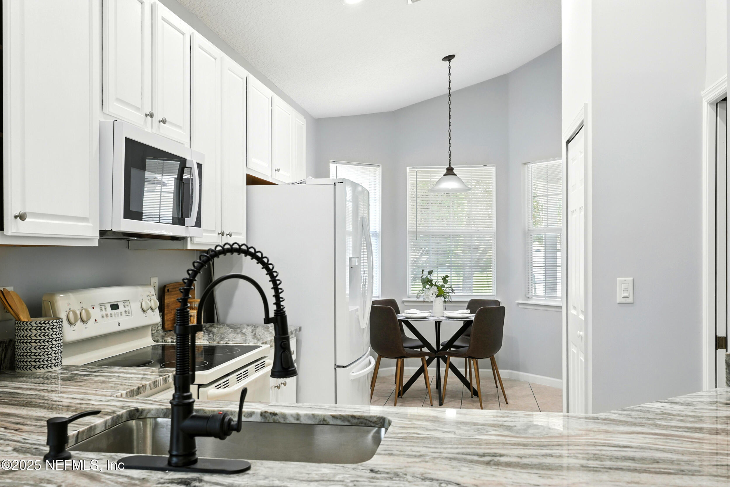 778 Copperhead Circle St. Augustine, FL 32092 - Photo 6 of 43 a dining room with furniture a chandelier and wooden floor