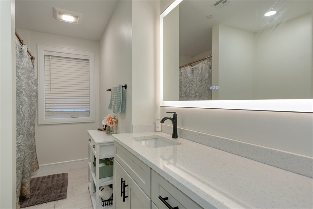 17 School Street, Unit A Hudson, MA 01749 - Photo 12 of 19 a bathroom with a sink and a mirror