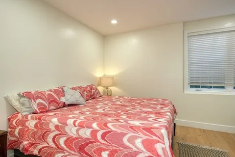 a bedroom with a bed and a couch