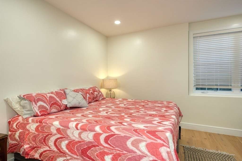 17 School Street, Unit A Hudson, MA 01749 - Photo 8 of 19 a bedroom with a bed and a couch