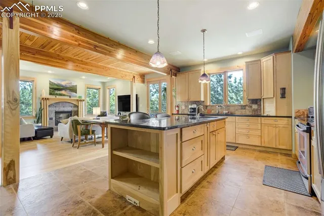 a kitchen with counter top space and living room view
