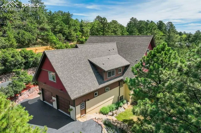 an aerial view of a house with yard and outdoor seating