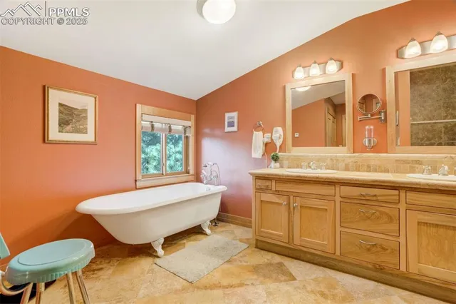 a spacious bathroom with a granite countertop sink and a mirror