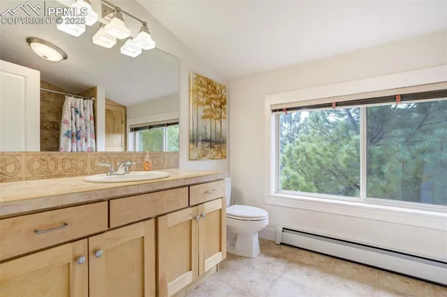 a bathroom with a granite countertop sink mirror and a large window
