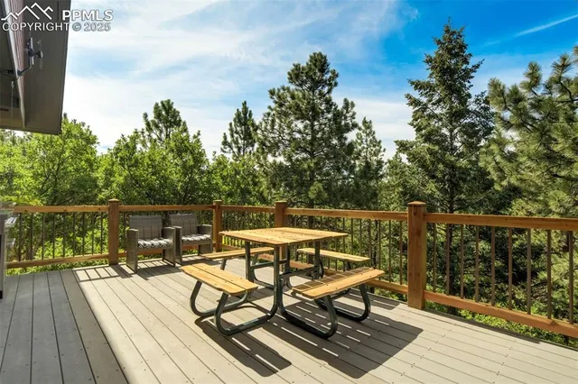 a view of a balcony with wooden floor and outdoor seating