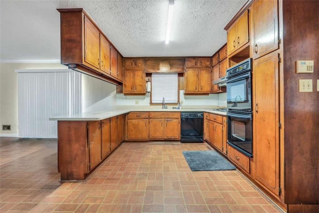 2058 Graham Road Macon, GA 31211 - Photo 12 of 37 a kitchen with stainless steel appliances granite countertop a stove top oven a sink and dishwasher