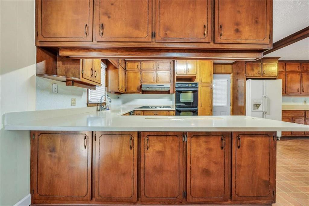 2058 Graham Road Macon, GA 31211 - Photo 13 of 37 a kitchen with stainless steel appliances granite countertop a refrigerator and cabinets