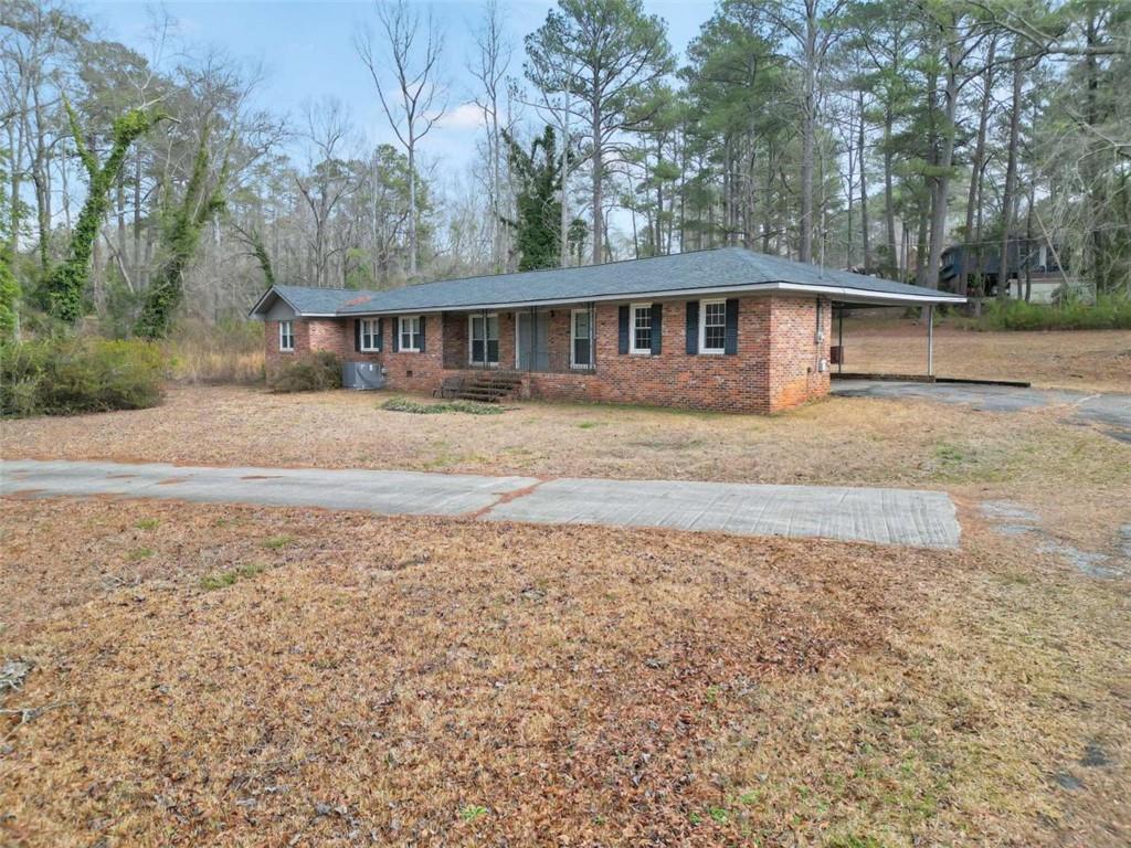 2058 Graham Road Macon, GA 31211 - Photo 16 of 37 a front view of a house with a yard and trees