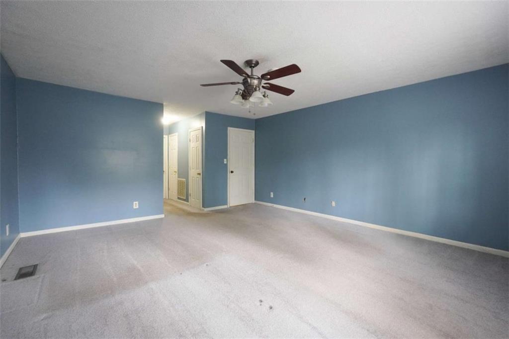 2058 Graham Road Macon, GA 31211 - Photo 18 of 37 an empty room with chandelier fan and windows