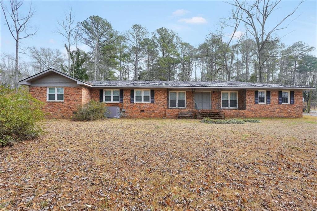 2058 Graham Road Macon, GA 31211 - Photo 2 of 37 a front view of a house with a garden and trees