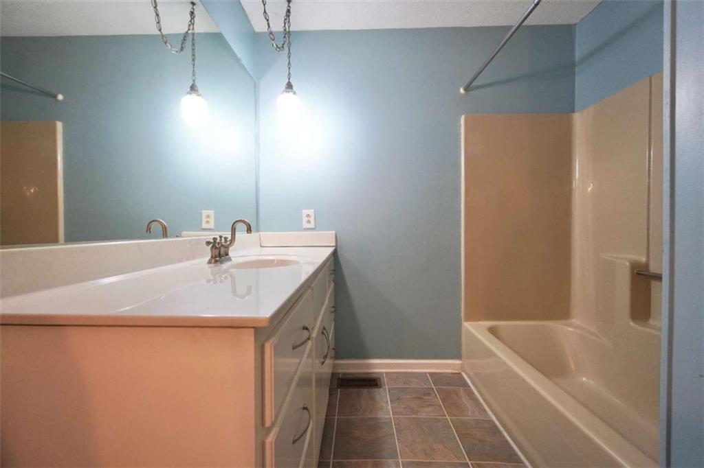 2058 Graham Road Macon, GA 31211 - Photo 21 of 37 a bathroom with a bath tub sink and a mirror
