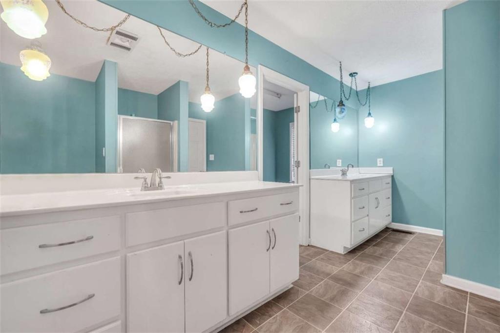 2058 Graham Road Macon, GA 31211 - Photo 23 of 37 a bathroom with a double vanity sink a mirror and a shower