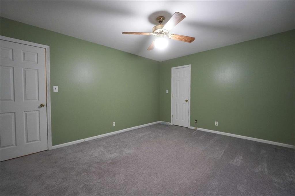 2058 Graham Road Macon, GA 31211 - Photo 27 of 37 an empty room with a chandelier fan and a chandelier fan