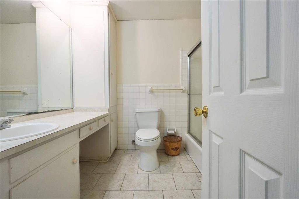 2058 Graham Road Macon, GA 31211 - Photo 33 of 37 a bathroom with a granite countertop toilet and a sink