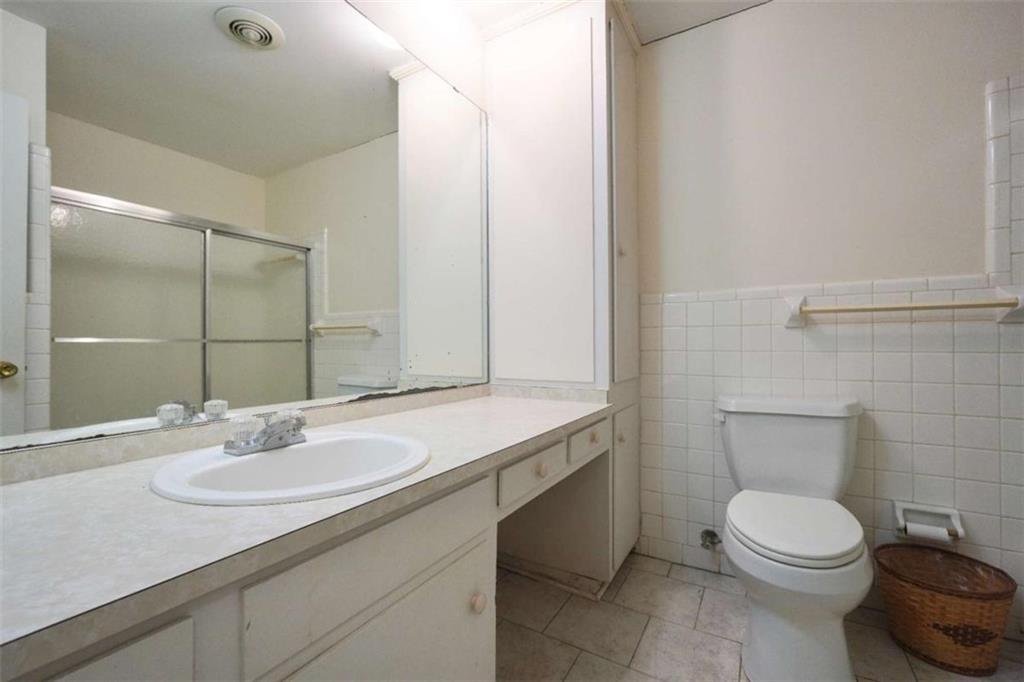 2058 Graham Road Macon, GA 31211 - Photo 34 of 37 a bathroom with a granite countertop sink a toilet and a mirror