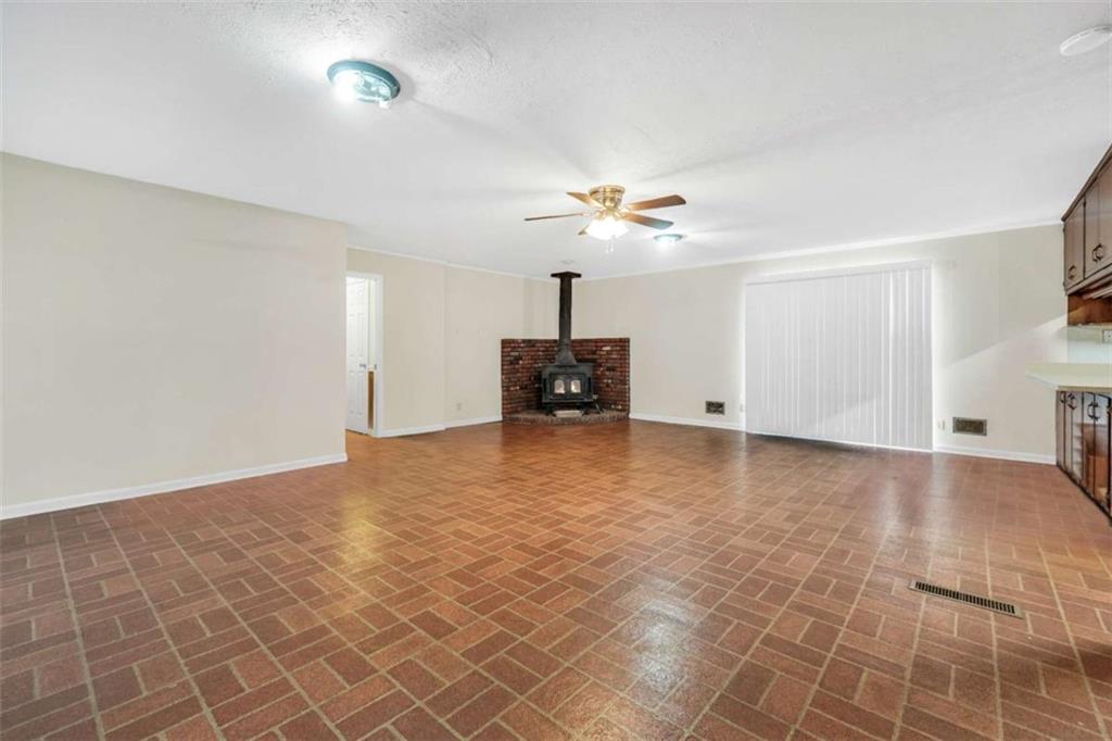 2058 Graham Road Macon, GA 31211 - Photo 5 of 37 a view of an empty room with a chandelier fan and windows