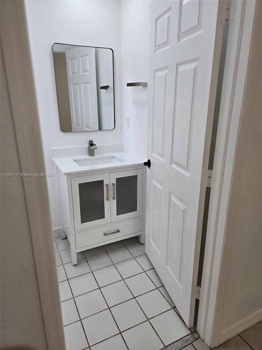 20137 Southwest 88th Court, Unit 20135 Cutler Bay, FL 33189 - Photo 16 of 33 a bathroom with a sink and a mirror