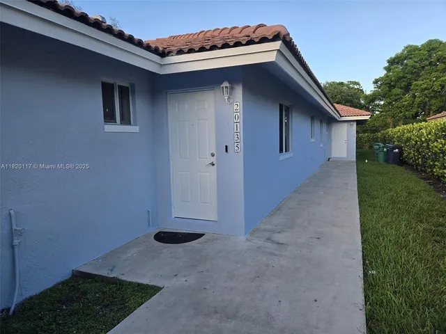 a backyard of a house with lots of green space