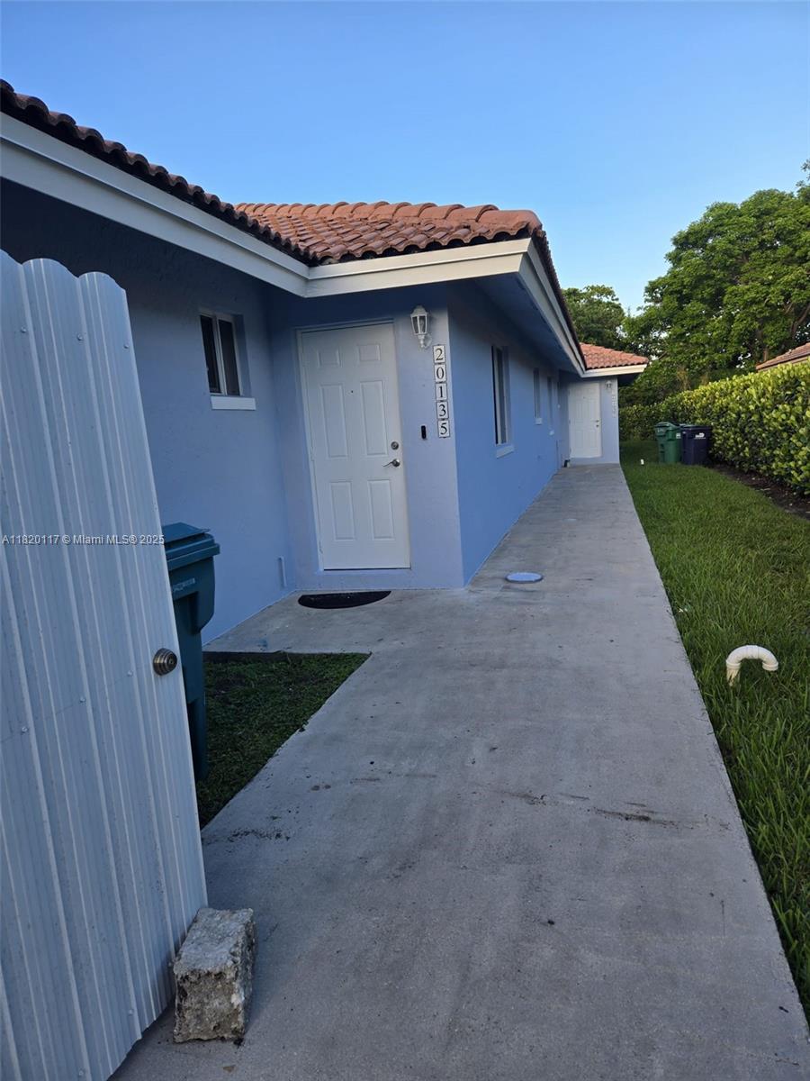 20137 Southwest 88th Court, Unit 20135 Cutler Bay, FL 33189 - Photo 24 of 33 a backyard of a house with lots of green space