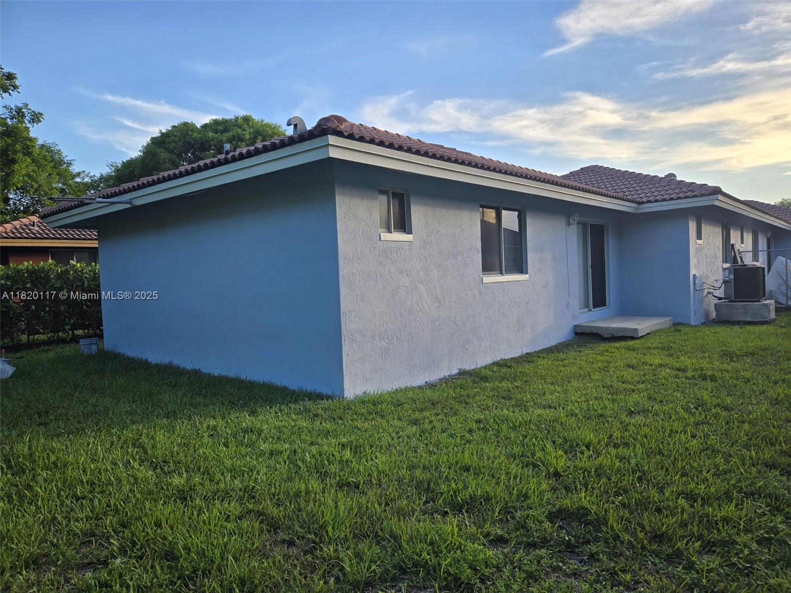 20137 Southwest 88th Court, Unit 20135 Cutler Bay, FL 33189 - Photo 25 of 33 a backyard of a house with lots of green space